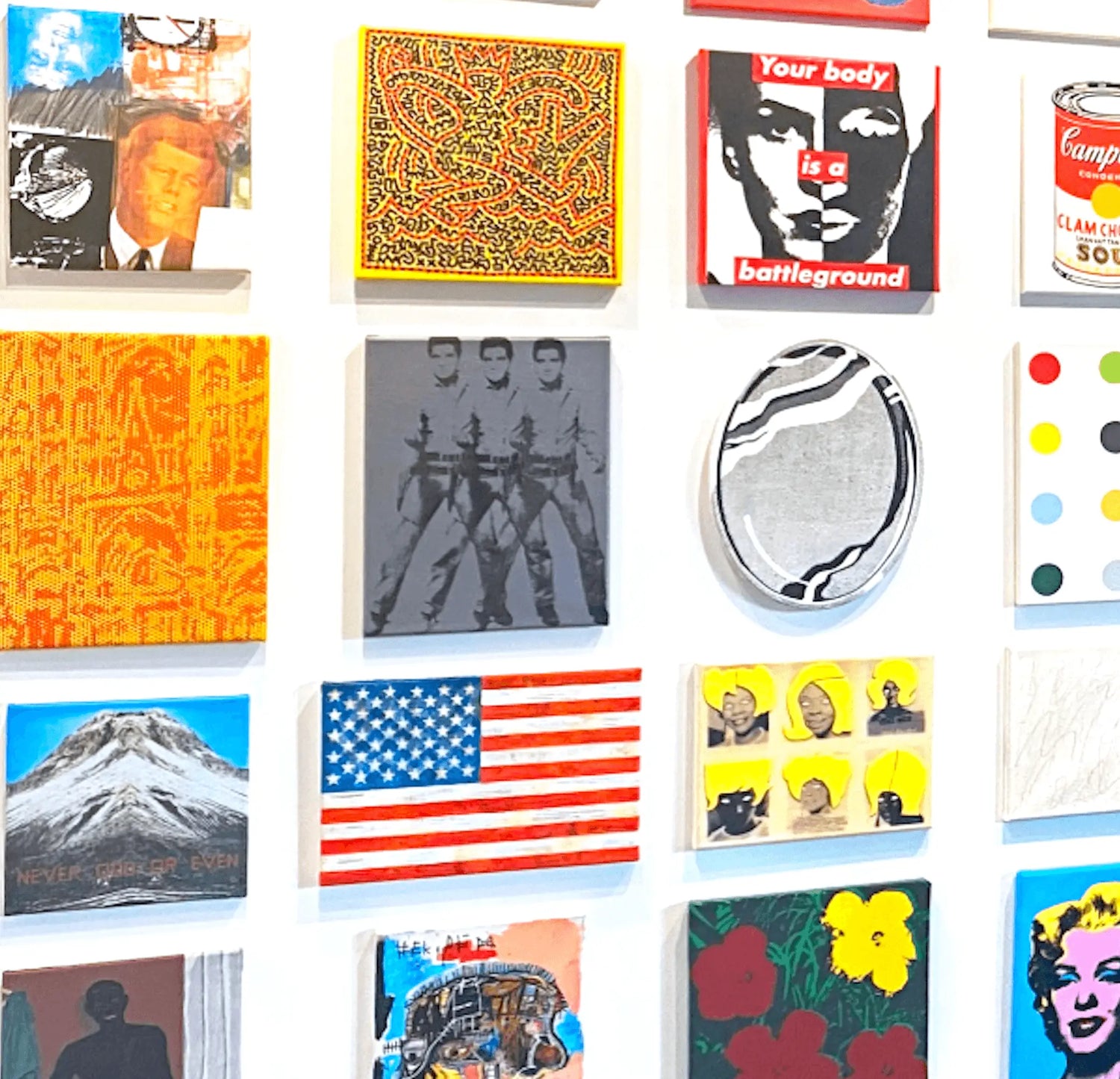 Gallery wall featuring diverse pop art and modern artworks including American flag, colorful portraits, abstract patterns