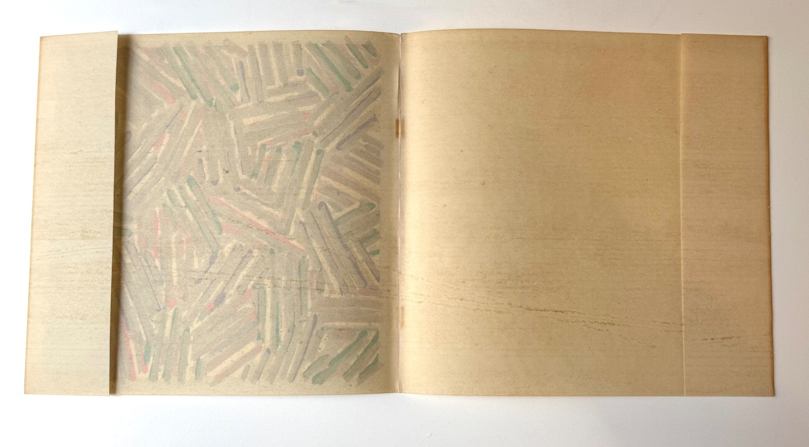 Verso authentic Jasper Johns Untitled Dust Jacket on Patapar parchment paper shows 5 decade toning, the full sheet shows folded dust jacket as published.
Courtesy Joseph K. Levene Fine Art, Ltd. 